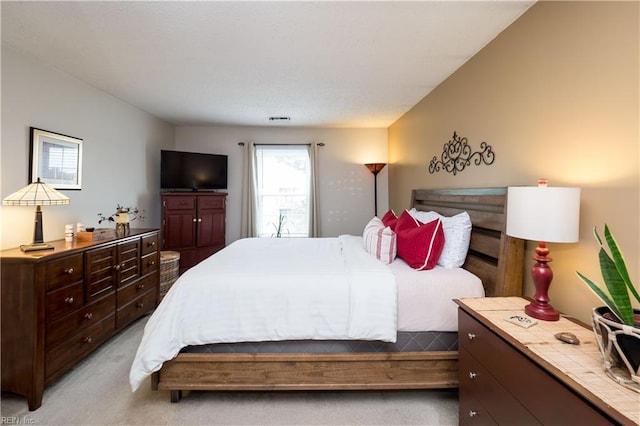 bedroom featuring light colored carpet