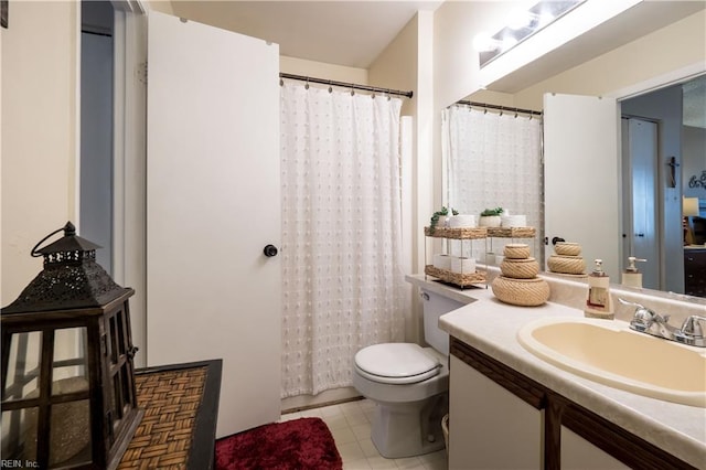 bathroom featuring curtained shower, tile patterned flooring, vanity, and toilet