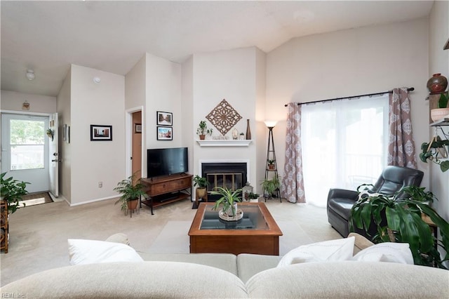 carpeted living room with lofted ceiling