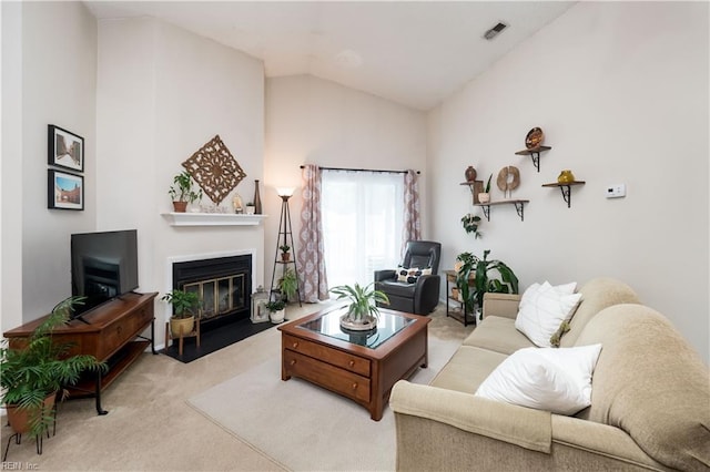 carpeted living room with high vaulted ceiling