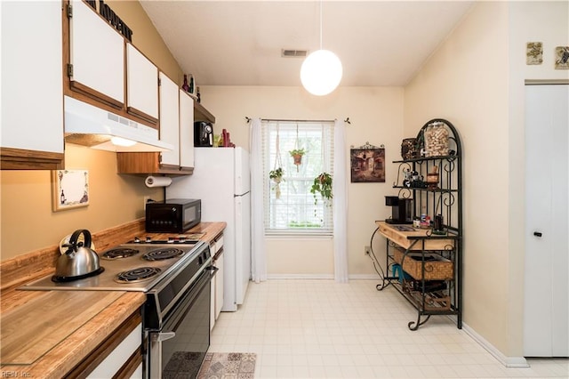 kitchen with hanging light fixtures, stainless steel range oven, white fridge, and white cabinets