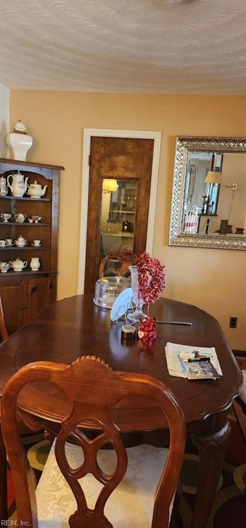 dining room featuring a textured ceiling