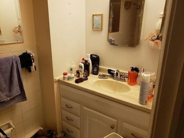 bathroom with vanity and tile walls