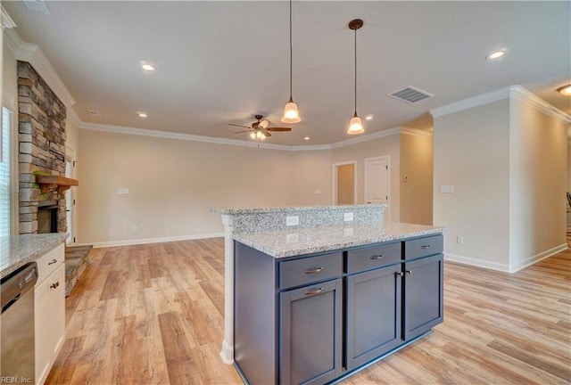 kitchen featuring light hardwood / wood-style flooring, dishwasher, ceiling fan, and a fireplace