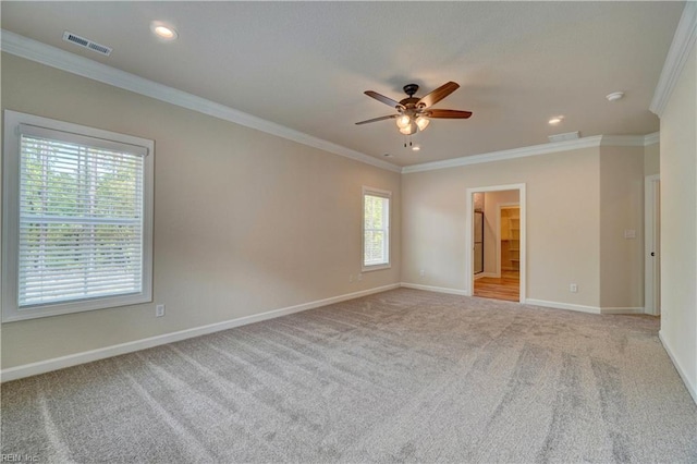 unfurnished room with ornamental molding, ceiling fan, and light colored carpet