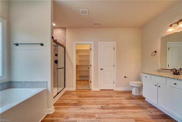 full bathroom featuring vanity, plus walk in shower, and hardwood / wood-style floors