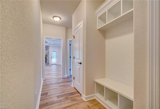 mudroom featuring light hardwood / wood-style floors and a textured ceiling