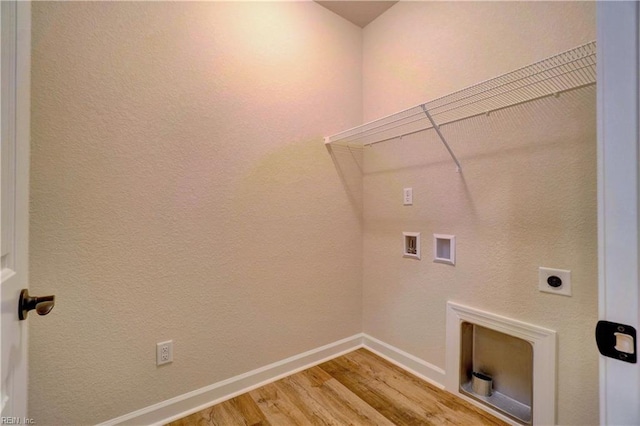 washroom featuring hookup for a washing machine, hardwood / wood-style floors, and hookup for an electric dryer