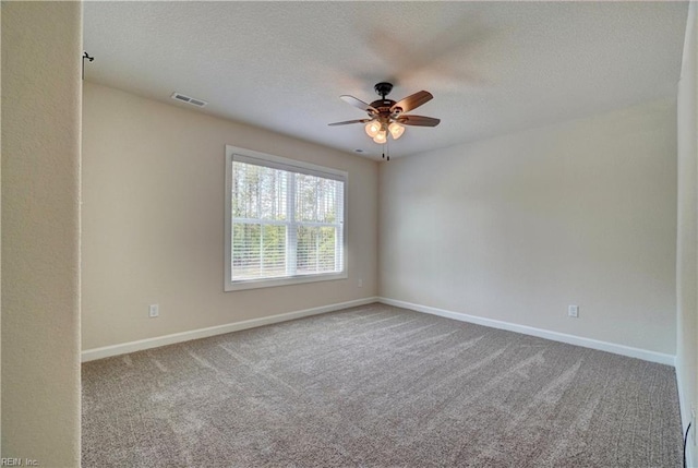 unfurnished room featuring ceiling fan, carpet floors, and a textured ceiling