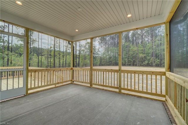 unfurnished sunroom with wood ceiling and a wealth of natural light