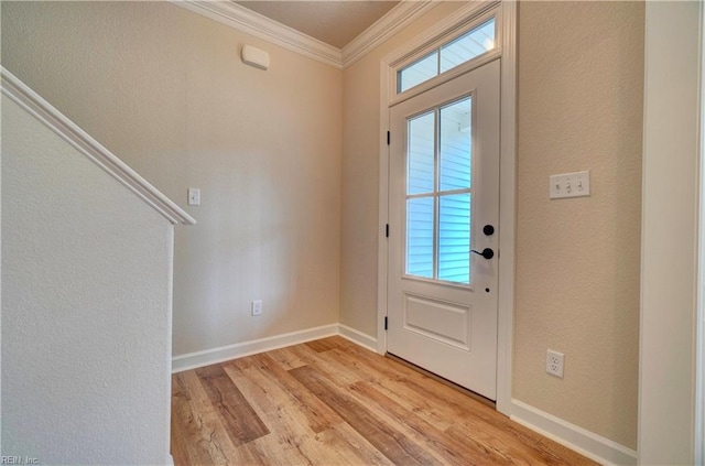 foyer entrance featuring crown molding and light hardwood / wood-style flooring