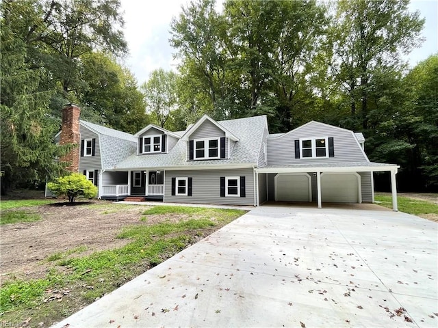 new england style home with a garage