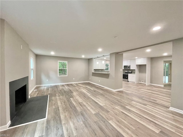 unfurnished living room featuring light wood-type flooring