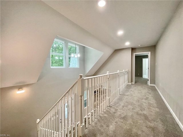 staircase with lofted ceiling and carpet flooring