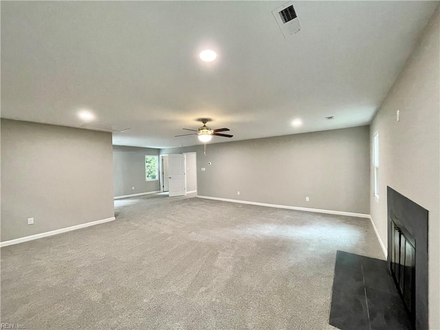 unfurnished living room featuring carpet floors and ceiling fan