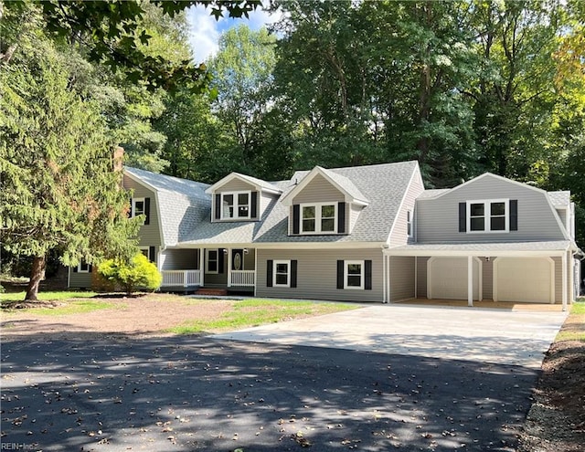 cape cod-style house featuring a garage and a porch