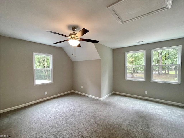 carpeted spare room featuring ceiling fan and lofted ceiling