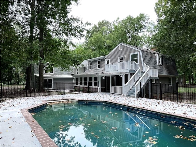 back of property with a pool side deck