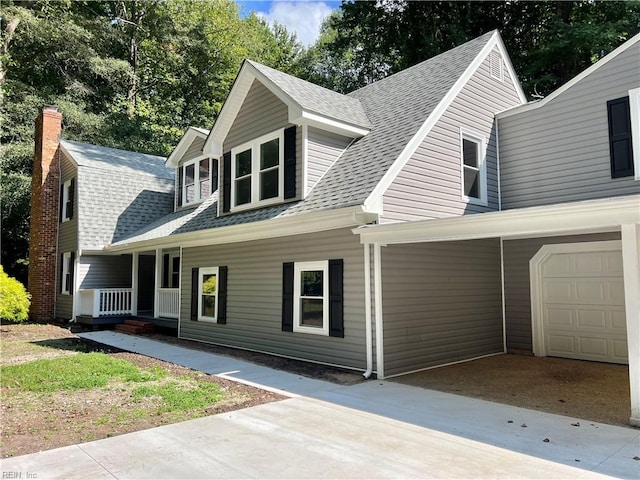 cape cod home with a porch and a garage