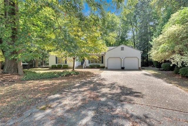 view of property hidden behind natural elements featuring a garage