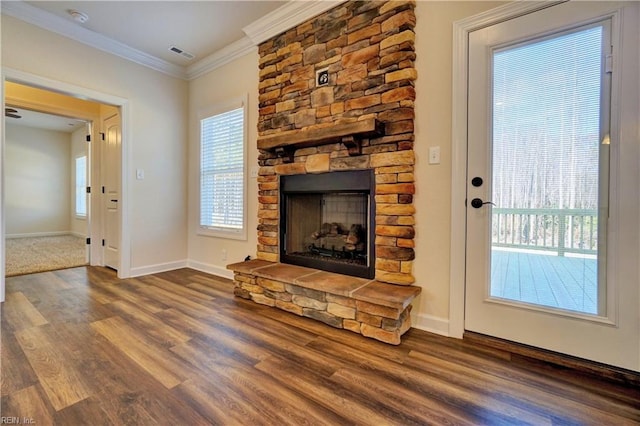 unfurnished living room featuring crown molding, a fireplace, and dark wood-type flooring