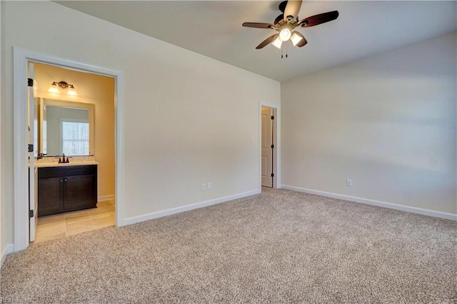 interior space featuring sink, ceiling fan, and light colored carpet