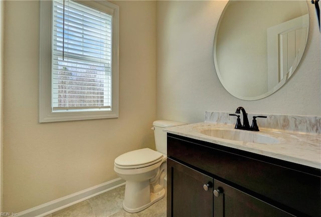 bathroom featuring vanity, tile patterned floors, toilet, and a healthy amount of sunlight