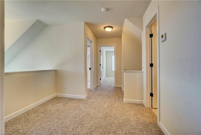 corridor featuring light colored carpet