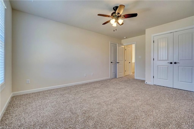 unfurnished bedroom with ceiling fan and light colored carpet