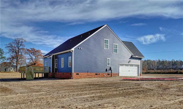 view of side of home with a wooden deck and a garage