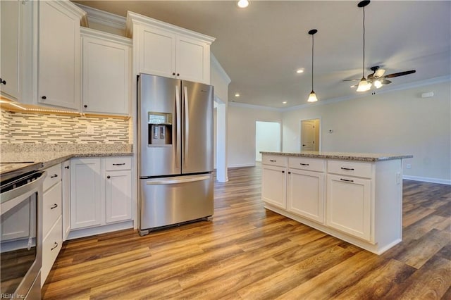 kitchen featuring stainless steel appliances, white cabinets, ceiling fan, and light hardwood / wood-style floors