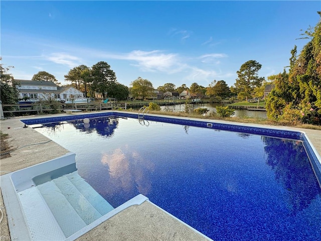 view of swimming pool featuring a water view