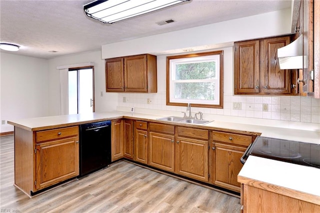 kitchen featuring kitchen peninsula, dishwasher, range hood, light hardwood / wood-style floors, and decorative backsplash