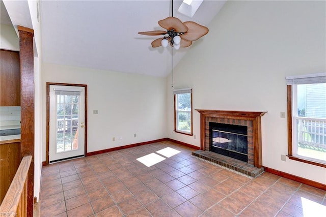 unfurnished living room with ceiling fan, a fireplace, high vaulted ceiling, and tile patterned floors