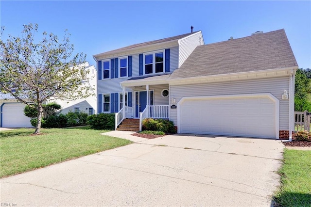 colonial home featuring a front yard and a garage