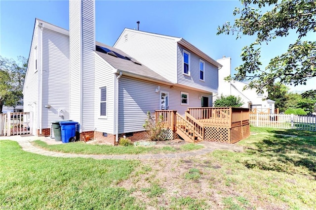 back of house with a lawn and a wooden deck