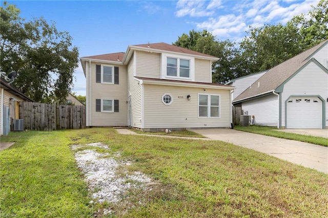 view of property featuring a front yard, a garage, and central air condition unit