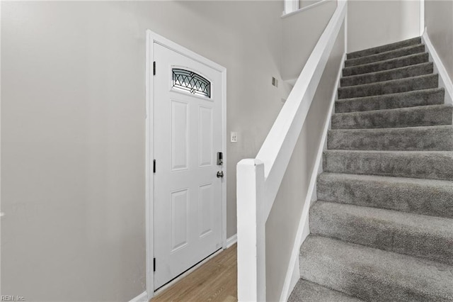 stairs featuring hardwood / wood-style flooring