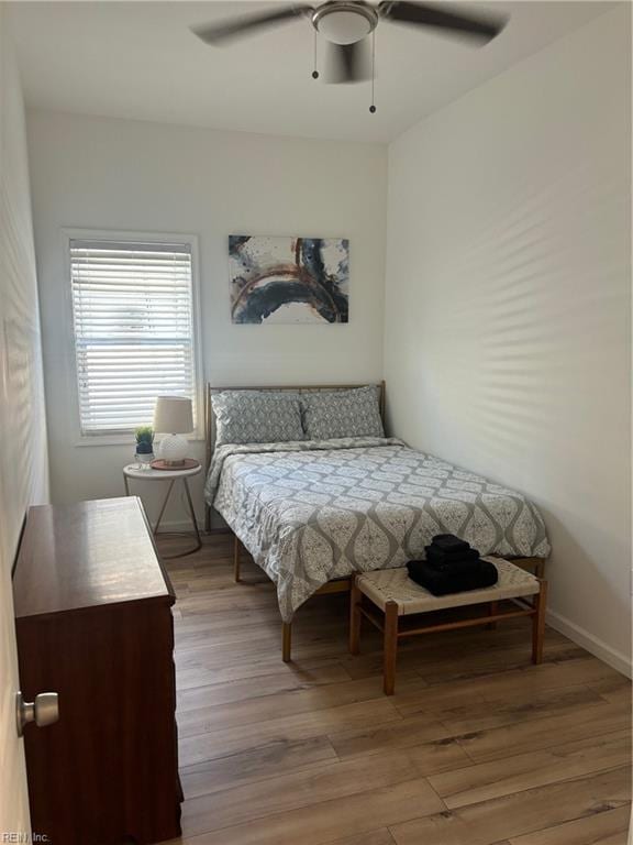 bedroom with ceiling fan and hardwood / wood-style flooring