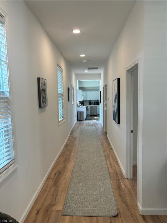 307 N First St, Hampton, VA 23664 - hallway with wood finished floors, a healthy amount of sunlight, and baseboards