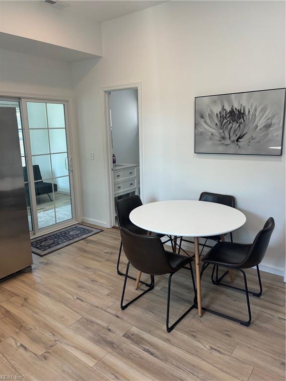 307 N First St, Hampton, VA 23664 - dining area with light wood finished floors, baseboards, and a healthy amount of sunlight
