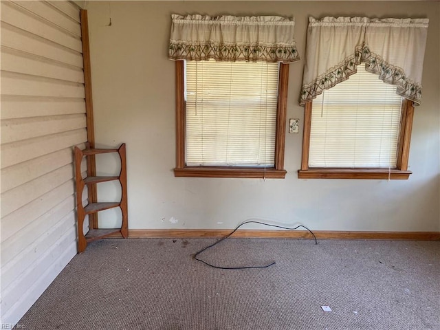 carpeted empty room with plenty of natural light