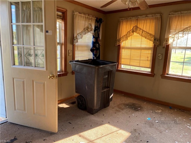 interior space featuring carpet floors, crown molding, and ceiling fan