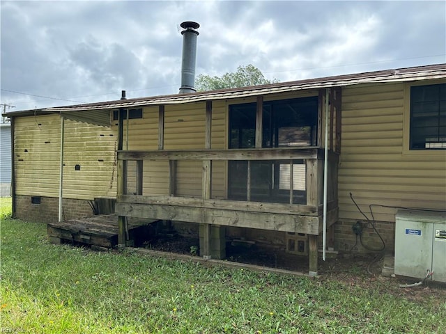 rear view of house with a yard