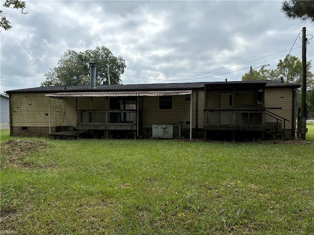 back of property with a lawn