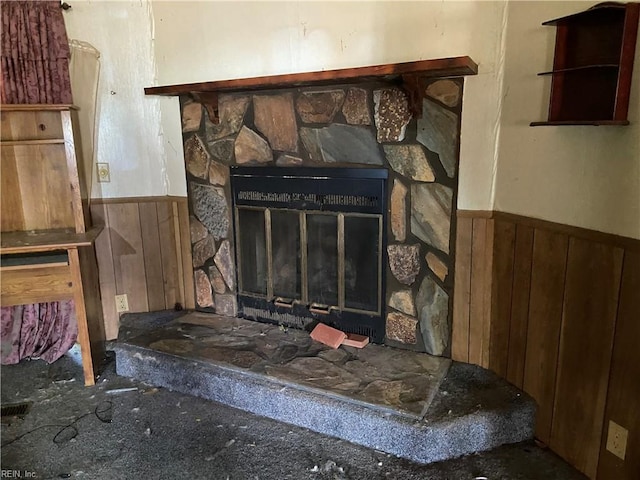 details featuring a stone fireplace and wooden walls