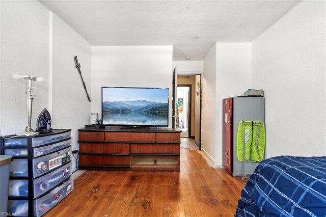 bedroom with dark hardwood / wood-style flooring