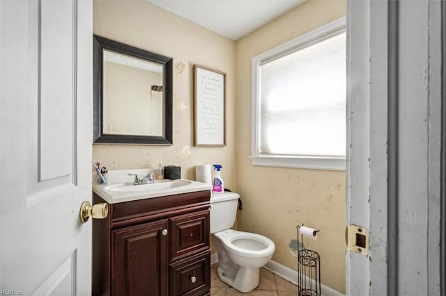 bathroom featuring tile patterned flooring, vanity, and toilet