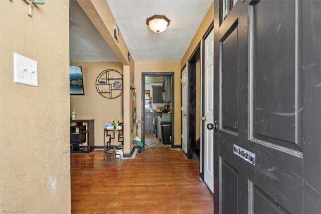 corridor with dark hardwood / wood-style flooring