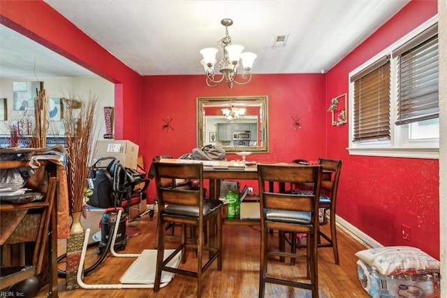 dining space featuring a chandelier and hardwood / wood-style floors